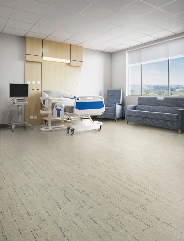 Interface Raw Materials plank LVT in Slate in a patient room.